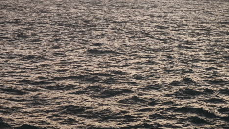 Wavy-open-sea-with-sun-reflecting-off-it-in-late-afternoon-from-mainland-Malta-to-Gozo