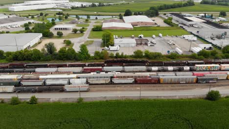 4k-aerial-view-panning-left-to-right-of-multiple-trains-and-one-starting-to-leave-the-train-station