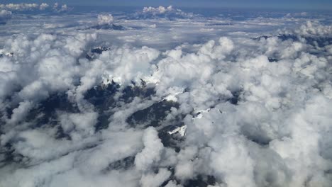 Aerial-view-above-white-clouds-and-snowy-moutain-top-of-peruvian-andes