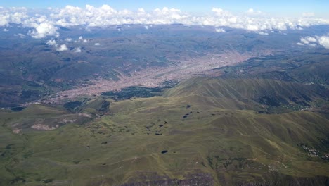 Airplane-mountain-view-of-Cusco-city-above-clouds-of-peruvian-andes