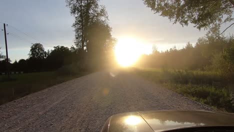 When-driving-along-a-gravel-road,-the-sun-shines-directly-into-your-eyes