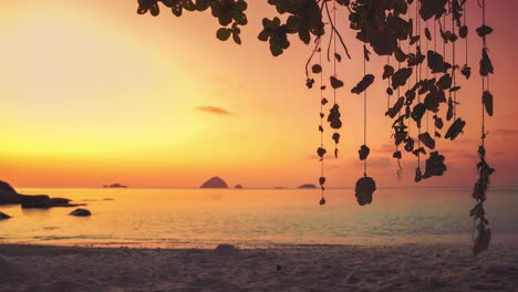 4K-UHD-Cinemagraph-of-a-mobile-gently-swinging-in-the-wind-at-a-beach-on-Perhentian-Island,-Malaysia-by-sunset
