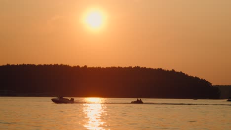 Motor-boat-speeds-down-the-lake-at-sunset