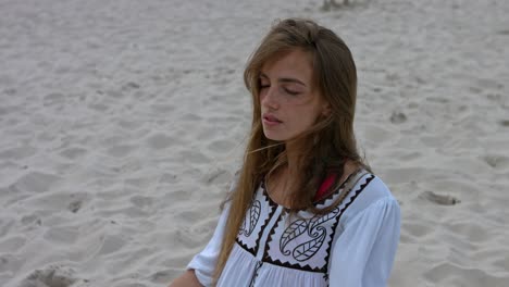 Eine-Frau,-Die-Im-Meditationsmoment-Allein-Im-Sand-Sitzt