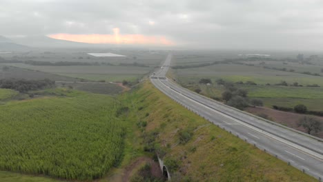 DRONE:-AERIAL-SHOT-OF-HIGHWAY-ON-CLOUDY-DAY