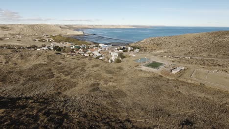 Small-town-called-Puerto-Piramides-at-the-peninsula-valdes-in-patagonia-argentina-drone-shot-moving-forward