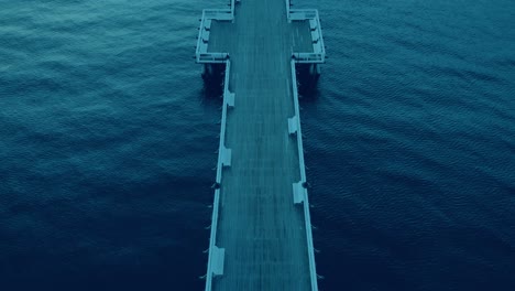 Aerial-footage-Over-Empty-wooden-pier-at-sunrise