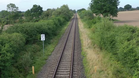 a-drone-flies-in-good-weather-at-a-very-low-altitude-over-railway-tracks