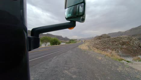 POV-of-the-passenger-of-a-parked-Class-A-RV,-point-of-view-of-Park-Lake-and-traffic-on-Highway-17-in-Washington-State-on-a-cloudy,-windy-day