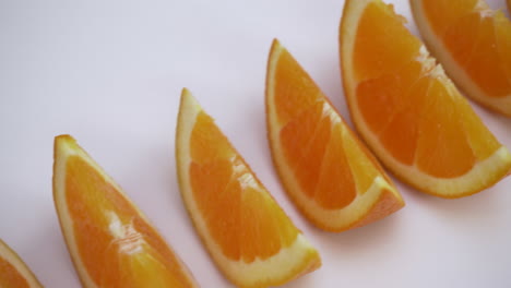 oranges-slices-in-a-row-moving-from-corner-to-corner,-healthy-fruit-isolated