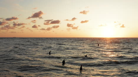 Surfers-in-front-of-the-touristic-town-Domburg-in-the-Netherlands-during-sunset
