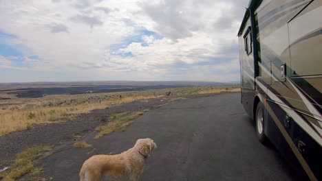 Pan-of-the-Okanogan-Highlands-of-north-central-Washington-State-with-a-recreational-vehicle-and-labradoodle-dog-in-the-foreground