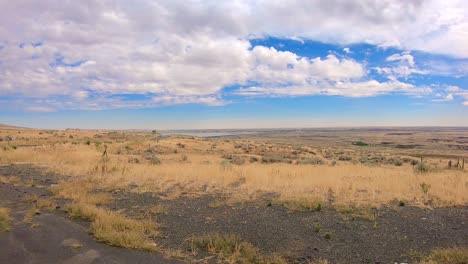 Panoramic-view-of-the-Okanogan-Highlands-of-north-central-Washington-State-with-traffic-and-Columbia-River-in-the-background