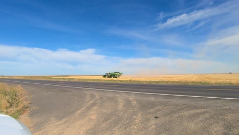 Combine-harvester-and-tractor-with-grain-trailer-are-harvesting-the-wheat-field-in-eastern-central-Washington-state