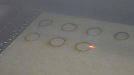 CO2-Laser-Cutter-Cutting-Circular-Holes-in-3mm-Plywood-Close-Up