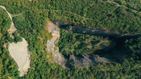 Aerial-footage-of-an-old-limestone-quarry-with-lakes,-Velka-Amerika,-Czech-Republic
