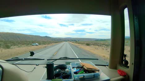 POV-of-the-passenger-while-riding-in-a-Class-A-RV-that-is-driving-along-the-cliffs-and-Okanogan-River-in-the-Okanogan-Highlands-of-north-central-Washington-State