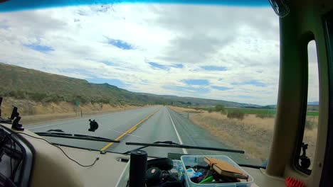 POV-of-the-passenger-while-riding-in-a-Class-A-RV-that-is-driving-along-the-cliffs-and-Okanogan-River-in-the-Okanogan-Highlands-of-north-central-Washington-State