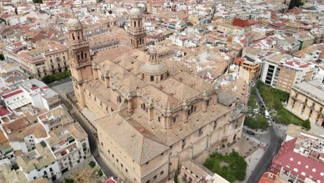 Spain-Jaen-Cathedral,-Catedral-de-Jaen,-flying-shoots-of-this-old-church-with-a-drone-at-4k-24fps-using-a-ND-filter-also-it-can-be-seen-the-old-town-of-Jaen