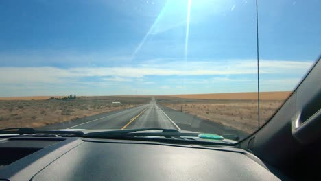 POV-out-of-the-windshield-on-the-passenger's-side-while-driving-thru-an-agricultural-area-of-Eastern-Washington-State