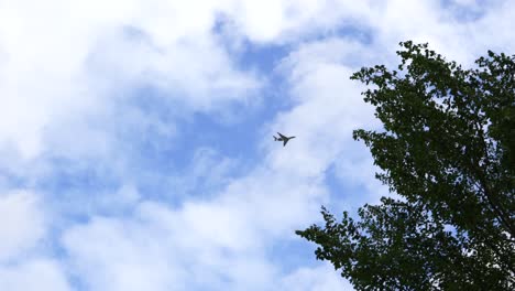 an-airplane-flies-over-the-camera-at-low-altitude-in-fine-weather