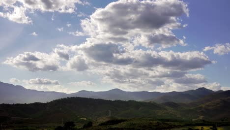4k-time-lapse-footage-of-clouds-moving-over-green-spanish-landscape,-shot-in-mountains-close-to-marbella,-malaga,-spain,-concept-showing-the-passing-of-time-on-a-sunny-summer-day