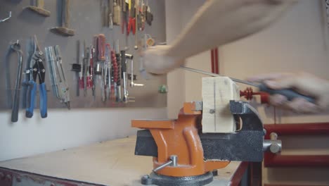 Sanding-Vice-Clamped-Wood-With-Hand-File-in-Workshop-Wide