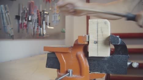 Sanding-Vice-Clamped-Wood-With-Hand-File-in-Workshop-Closeup