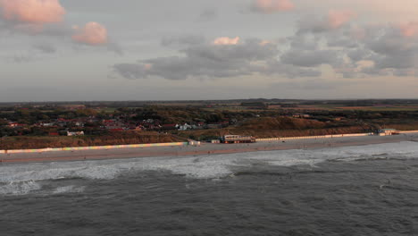 Surfers-in-front-of-the-touristic-town-Domburg-in-the-Netherlands-during-sunset