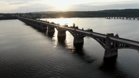 Aerial-drone-follows-traffic-on-bridge-crossing-Susquehanna,-York-and-Lancaster-County,-Pennsylvania