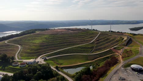 Aerial-pan-of-modern-landfill,-sewage-treatment,-wind-and-hydro-power,-Susquehanna-River-in-Pennsylvania