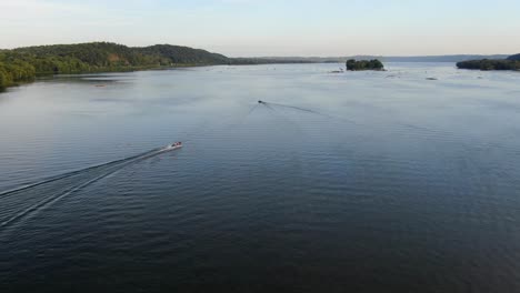 Wide-aerial-drone-shot-above-mighty-Susquehanna-River,-two-speeding-boats-below