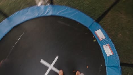 POV.-Male-jumping-on-trampoline-in-garden-setting