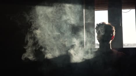 Silhouette-of-a-man-vaping-in-the-dark-in-slow-motion