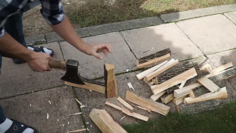 Young-man-is-chopping-wood-in-smaller-pieces