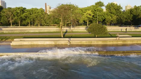 60-Frames-Per-Second---Static-aerial-shot-of-people-exercising-along-Chicago's-Lakeshore-Path-as-waves-crash-onto-path-due-to-high-water-levels