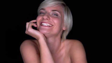 Front-view-happy-natural-blond-woman-smiling-with-beautiful-healthy-white-smile-to-camera