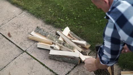 Young-man-is-chopping-wood-in-smaller-pieces