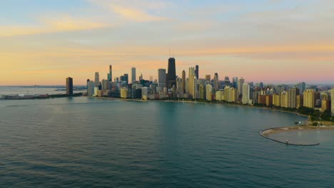 Aerial-Push-in-towards-Chicago's-skyline-during-summer-sunrise
