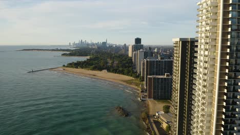 Aerial-shot-of-High-Rise-Condominiums-along-the-Water-with-Chicago-skyline-in-background-[4k