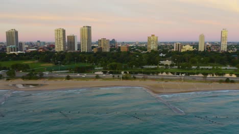 Aerial-shot-panning-across-Chicago's-beaches-during-a-summer-sunrise