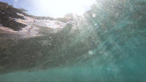 Extreme-Slow-Motion-underwater-view-of-a-shore-break-wave-shot-from-below-the-wave