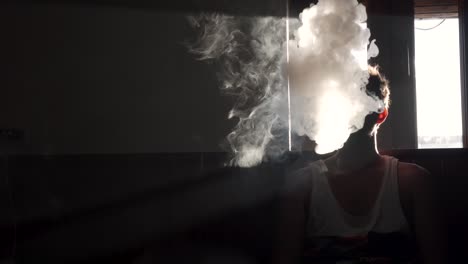 Man-vaping-in-the-darkness-of-a-room