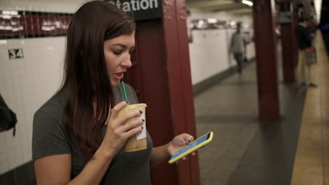 Young-Attractive-female-waits-for-subway-train-to-arrive-at-a-New-York-Subway-station