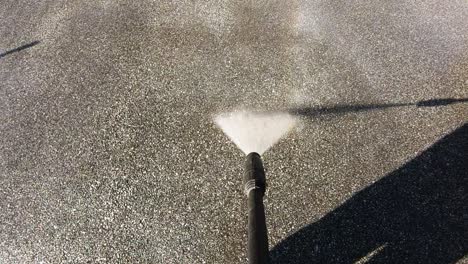 Driveway-cleaning-with-high-pressure-water-jet,-slow-motion,-nobody