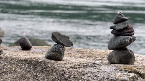 Close-up-of-cairns-stacked-on-boulder-on-ocean-beach