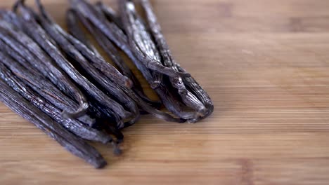 Dried-vanilla-beans-on-a-wooden-background-with-copy-space