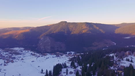 Aerial-view-of-the-tourist-sport,-Ski-area-and-recreational-resort-on-the-mountain-Jahorina-at-sunset,-Bosnia-and-Herzegovina