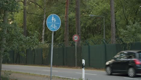 German-street-signs-and-a-car-passing-by