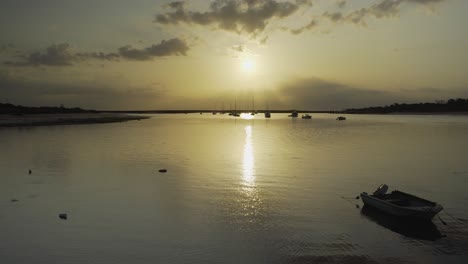 River-sunshine-in-the-morning-with-silhouette-boats-floating-Tavira-Portugal